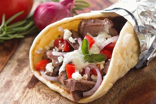 Foto Gyros de comida rápida griega: tortilla con cordero y salsa de zaziki