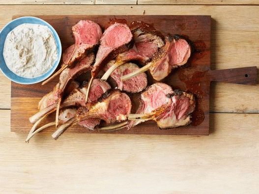 Photo Rack de cordero en una mezcla de especias con salsa de yogurt con hierbas frescas