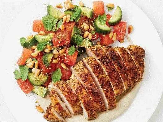 Foto de pollo frito sazonado con zaatar con ensalada de sandía